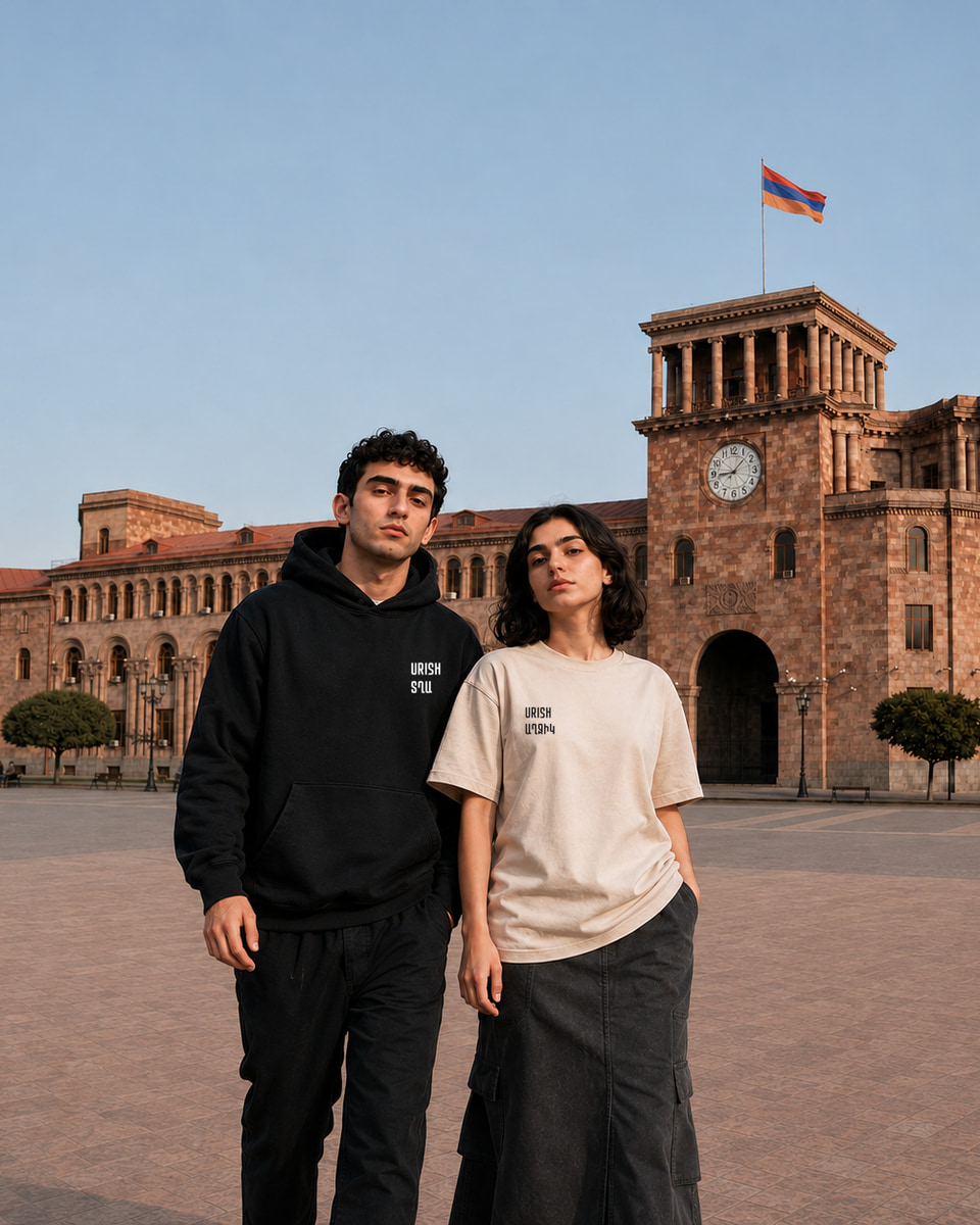 Two models in Republic Square wearing a black URISH hoodie and a beige URISH T-shirt