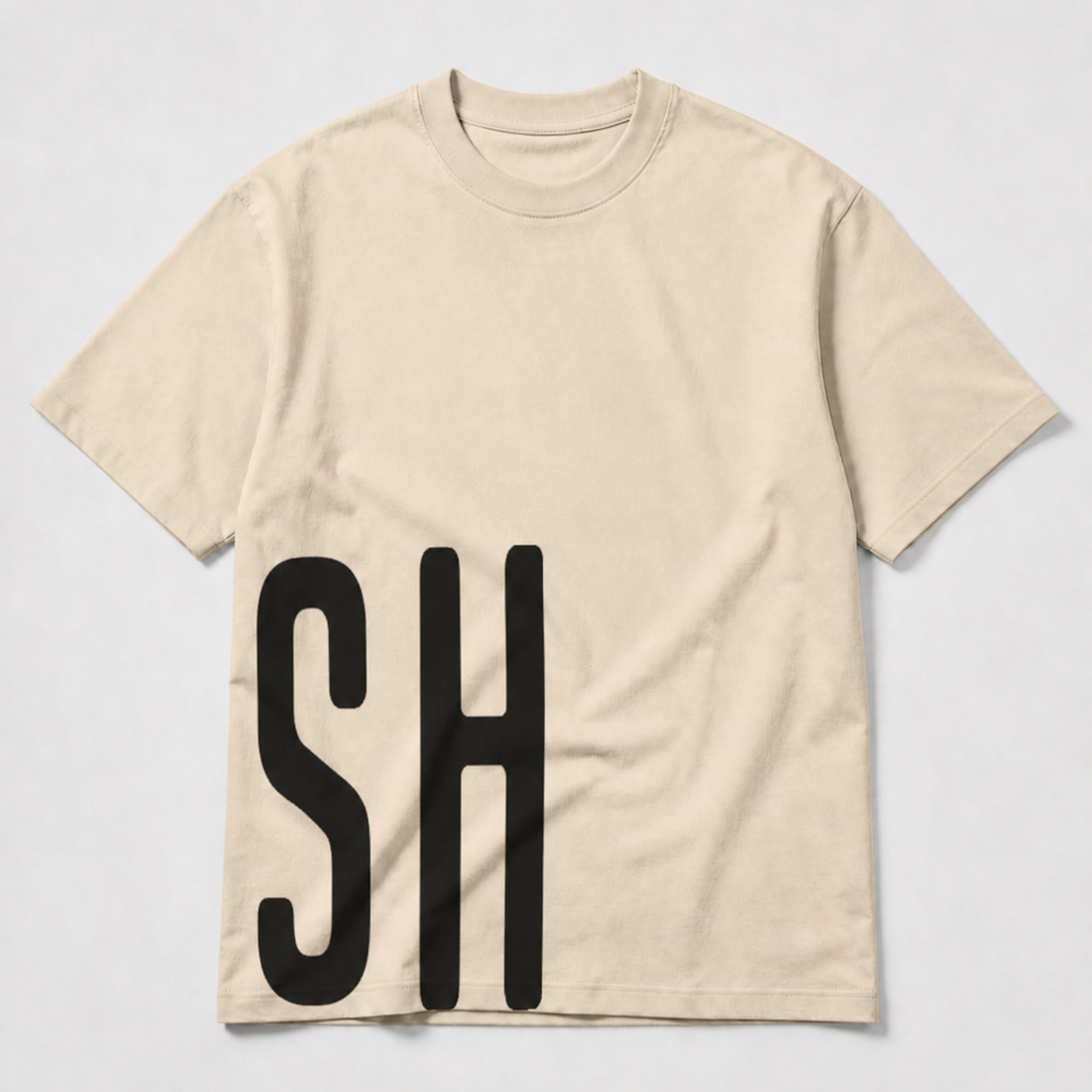 Front view of the URISH Wrap beige T-shirt with black “URISH” lettering continuing from the back to the front